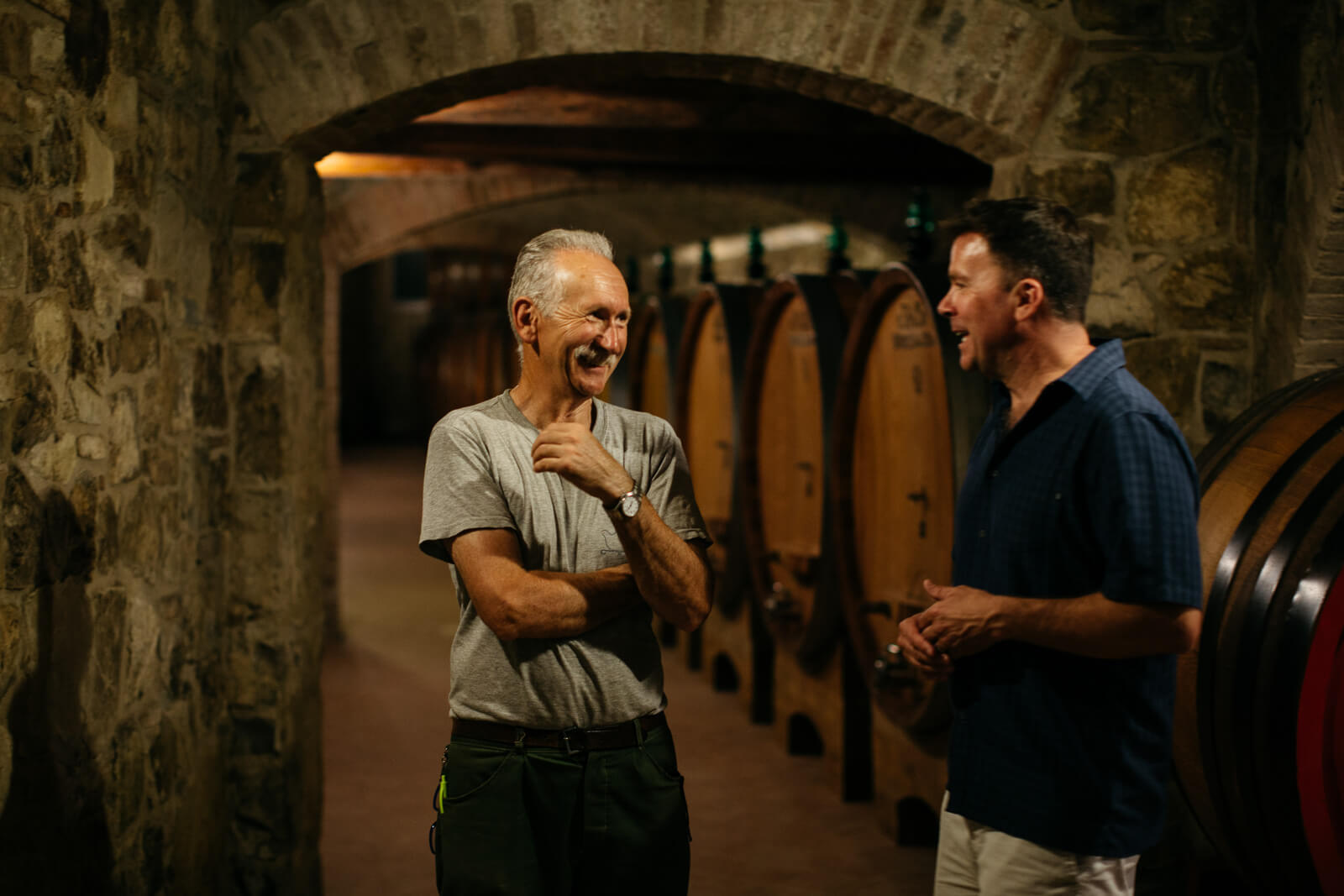 todd speaking with wine distiller in cellar
