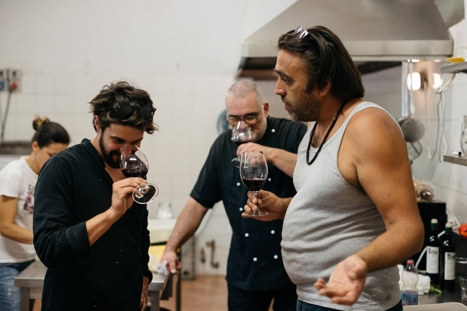 Group of people smelling glasses of red wine
