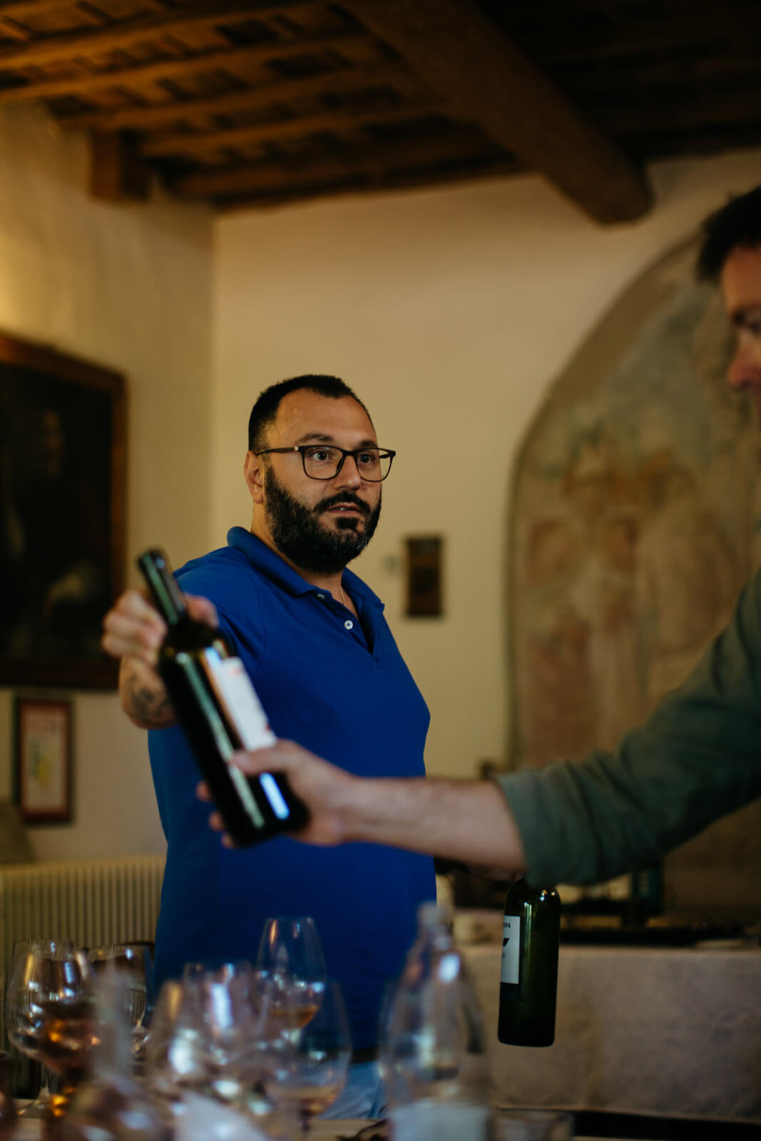 Person inspecting a bottle of wine